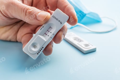 Preview: Positive Covid-19 antigen test in hand. Coronavirus antigen rapid test.
