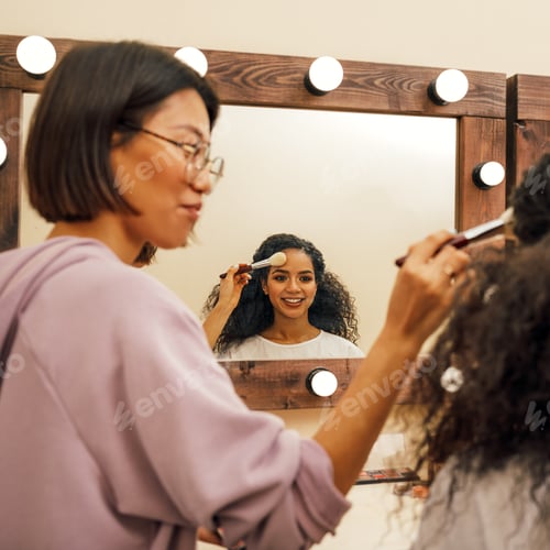 Preview: Make up artist and model preparing for photoshoot in dressing room