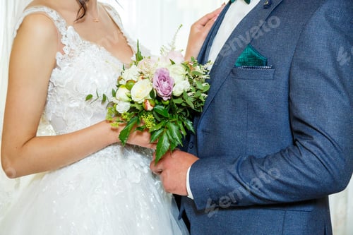 Preview: Beautiful wedding bouquet of flowers in the hands of the newlyweds