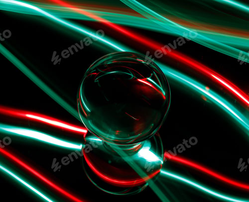 Preview: Intriguing green and red light emanating from a light bulb in a dimly lit setting