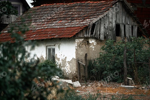 Preview: Natural view of an old and abandoned house with blurred bush foreground