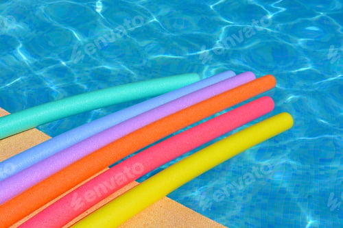 Preview: Rainbow pool noodles at poolside in summer