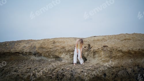 Preview: Dance artist moving body sensually on rocks summer day. Romantic girl dancing