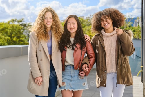 Preview: Diverse friends in autumn outfits standing on terrace