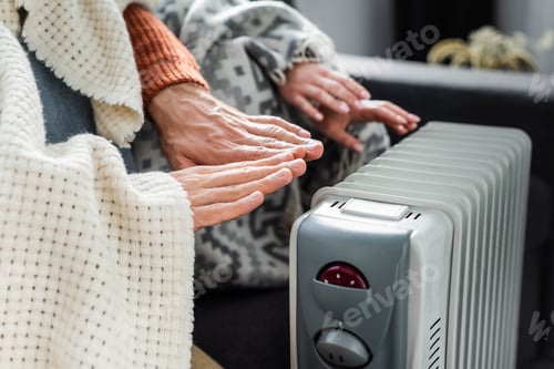 Preview: cropped view of girlfriend and boyfriend covered with blankest warming up near heater