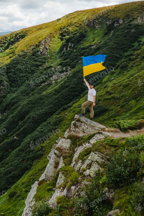 Preview: A man on the mountains with a ukrainian flag