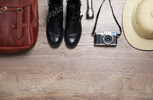 Preview: Flat lay composition with different safari accessories on wooden background, space for text