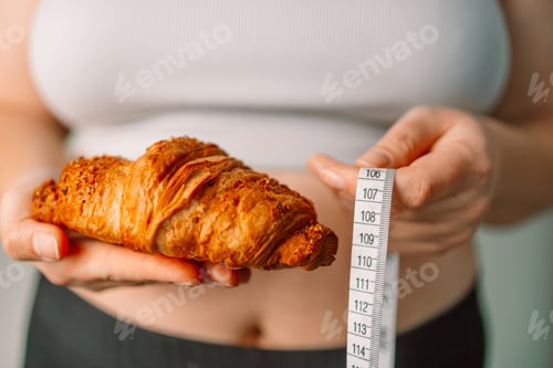Preview: Person's hand holding green apple with grey measurement tape isolated on white background. Weight