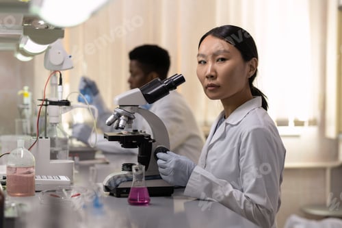 Preview: Woman with microscope at the lab