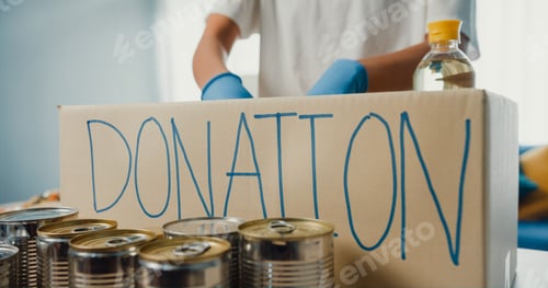 Preview: girl volunteer wear gloves packing food and drinks donation into donations paper boxes.