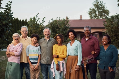 Preview: Happy multi-ethnic extended family in the backyard looking at camera.