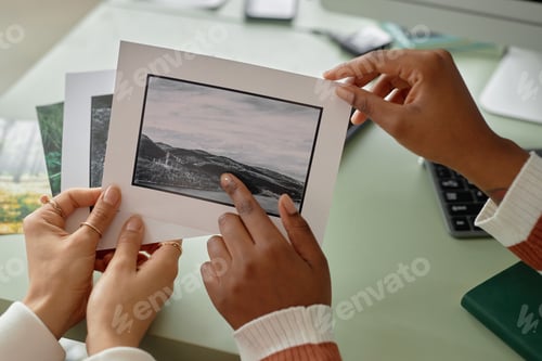 Preview: Close Up of Two Women Holding Photo Prints