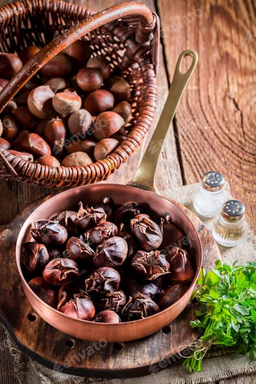 Preview: Hot chestnuts with garlic sauce on old wooden table