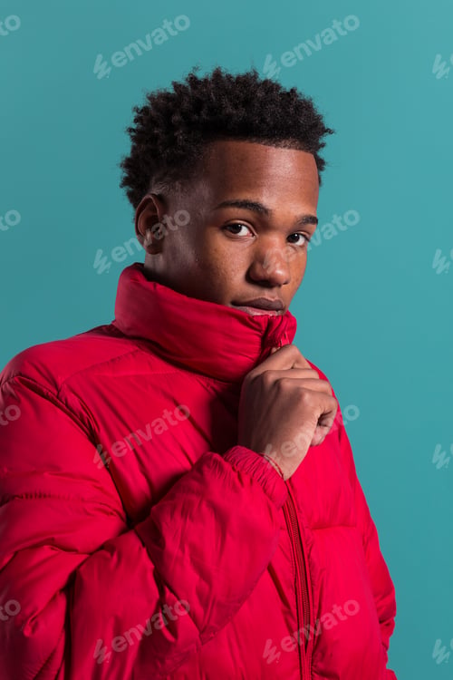 Preview: Trendy man in coat and headphones