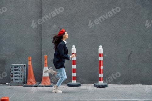 Preview: Fashion woman running down the street in front of the city tourist in stylish clothes with red lips