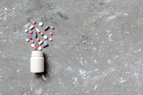 Preview: Pills spilling from a medication bottle on background