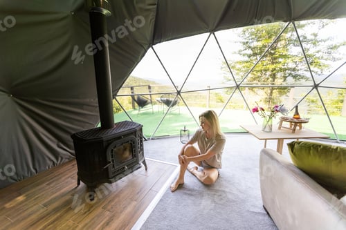 Preview: a woman enjoys solitude inside of a transparent bubble hotel.