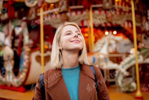 Preview: blonde woman near carousel at the Christmas market