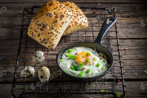 Preview: Homemade and hot fried eggs served with chive and roll.