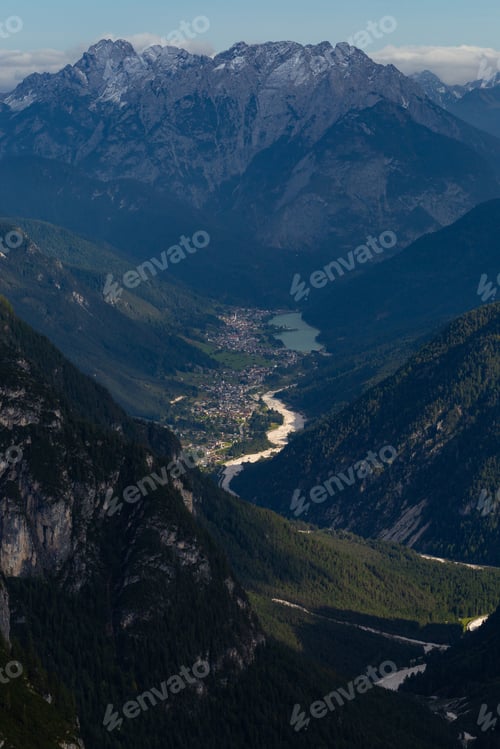 Preview: Vertical high angle shot of a breathtaking view of a village at the foot of the Italian Alps