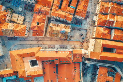 Preview: Aerial view of houses with orange roofs at sunset in summer