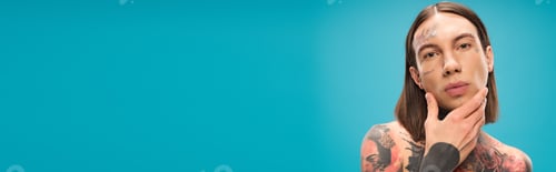 Preview: young and man with tattoo touching smooth face isolated on blue, banner