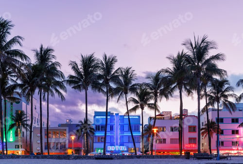 Preview: Colorful Art Deco hotels on Ocean Drive in Miami Beach glow under the warm hues of a vibrant sunset