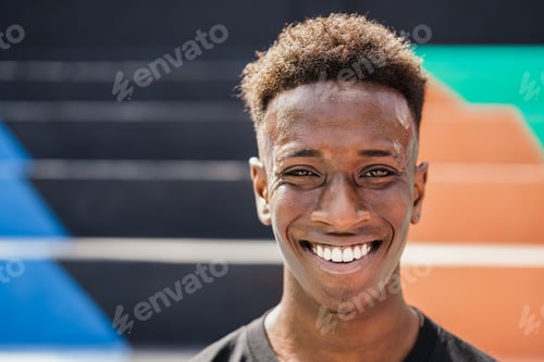 Preview: Happy African man smiling at camera outdoor - Focus on face