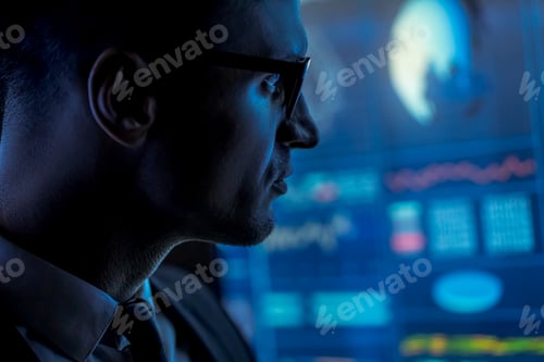 Preview: The man in suit works with data on a blue screen