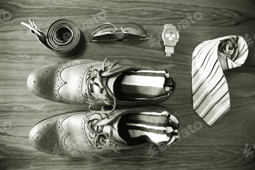 Preview: Overhead flat lay mens clothing and accessories in black and white monochrome