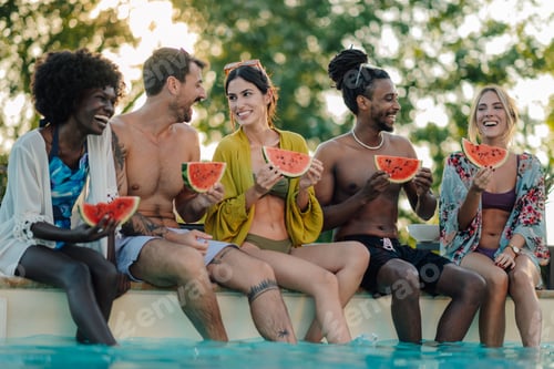 Preview: Happy friends eating watermelon slices, sitting at poolside and enjoying summer vacation