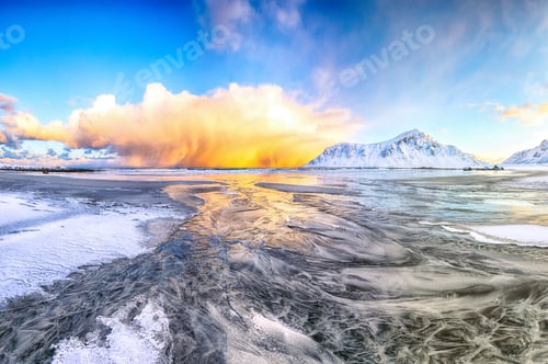 Preview: Incredible winter scenery on Skagsanden beach with illuminated clouds during sunrise.