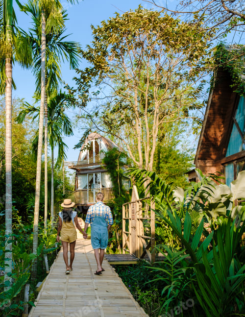 Preview: wooden cottage surrounded by palm trees and a vegetable garden in the countryside. cabin rainforest