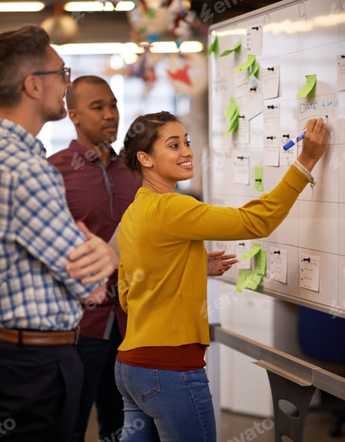 Preview: Shot of a group of coworkers brainstorming at a whiteboard