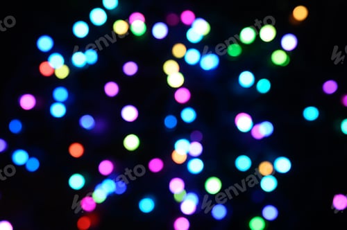 Preview: blurred night multicolored glowing lights on black background. new year and christmas concept