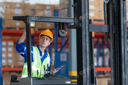 Preview: Worker in auto parts warehouse use a forklift to work to bring the box of auto parts
