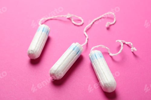 Preview: Three tampons on pink background, close up