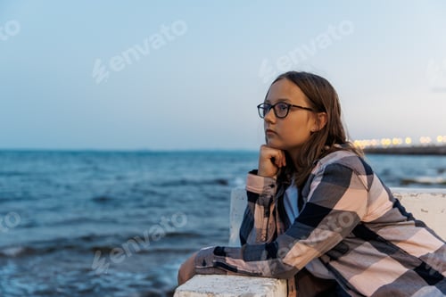 Preview: Portrait of a teenage girl by the sea on a summer evening