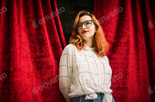 Preview: Attractive redhaired woman in eyeglasses