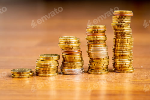 Preview: Closeup of pile of coins on a wooden surface