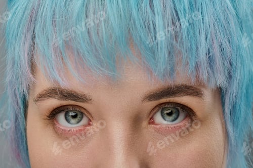 Preview: Vibrant young woman with striking blue hair and captivating eyes in a stylish urban setting