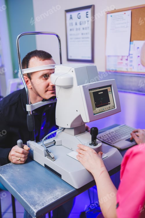 Preview: A young man at an oculist's appointment checks his vision with a modern microscope.