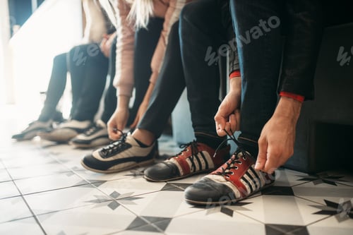 Preview: Bowling players ties shoelaces on house shoes