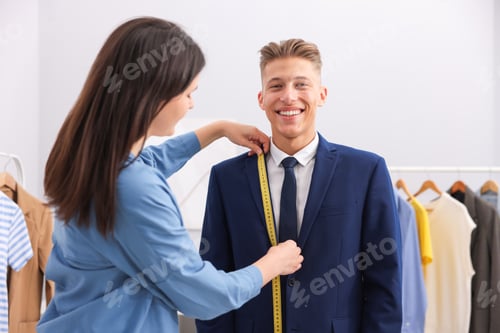 Preview: Tailor measuring jacket on man in atelier