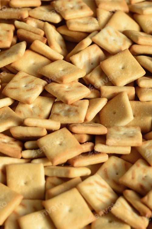 Preview: A lot of small cookies are square shaped. A pattern of a yellow salt cracker. Background