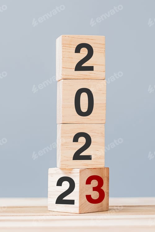 Preview: 2022 change to 2023 wooden cube blocks on table background.