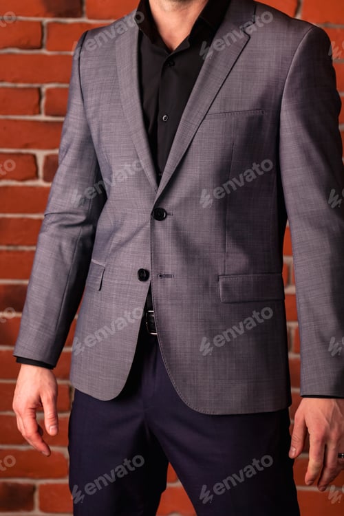 Preview: Handsome young handsome businessman in casual gray jacket close up.