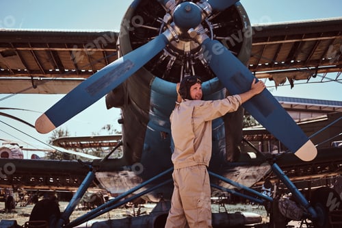 Preview: Smiling pilot is checkin his jet.