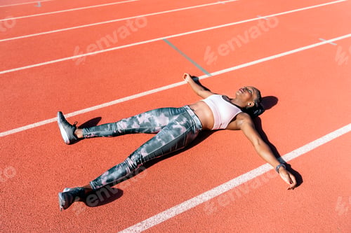 Preview: Young athlete sprinter lying down