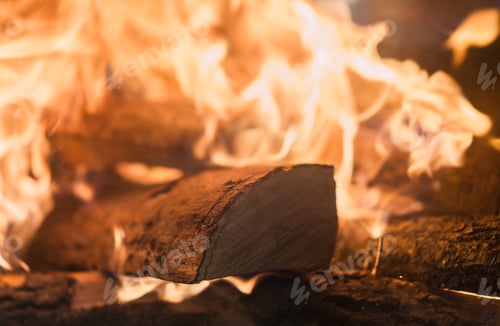 Preview: Logs on fire in a home fireplace